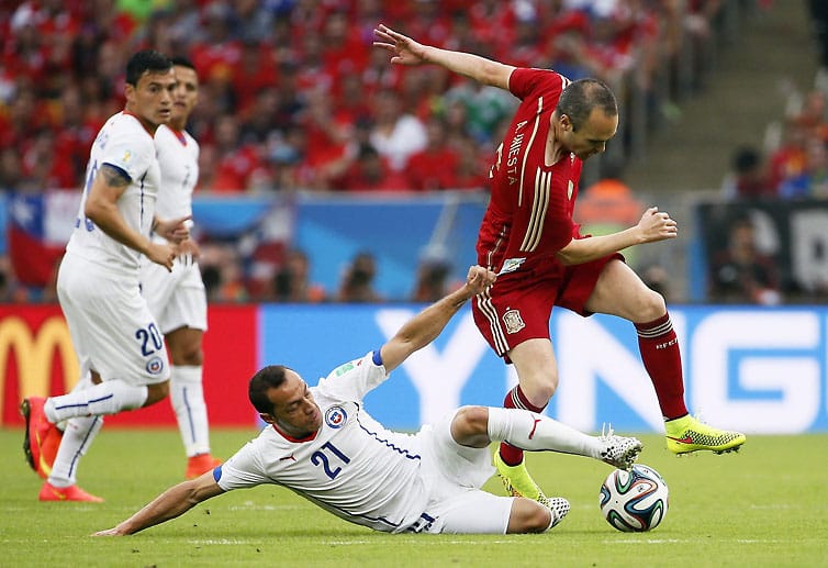 Im weiteren Spielverlauf lässt Chile keine zwingenden Chancen der Spanier zu. Andres Iniesta (re.) wird immer wieder im Spielaufbau gestört.