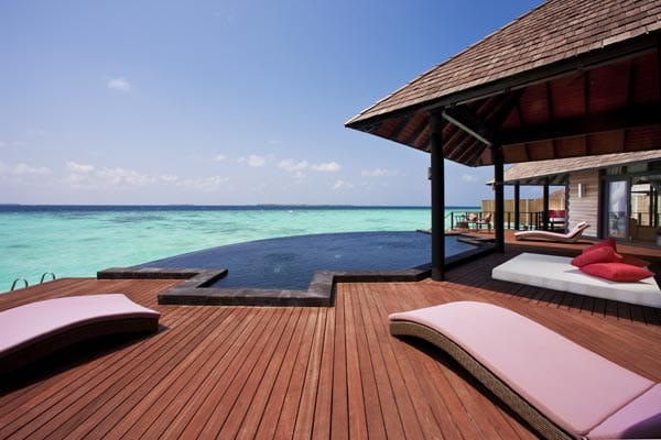 Gäste des Hilton Maledives / Iru Fushi Resort & Spa können vom Pool ihren Blick über das azurblaue Wasser des Indischen Ozeans schweifen lassen und die Sonne der Malediven genießen.