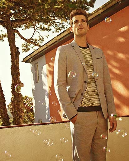 Klasse kombiniert: Der klassische Rundhals-Pullover (um 180 Euro von Ted Baker) mit Sakko und Bundfaltenhose machen diesen Look absolut stilecht.