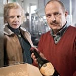 Welche Rolle spielt das Ehepaar Schosser (Sunnyi Melles und Uwe Preuss), das erst behauptet, Bensao hätte ihnen portugiesischen Wein andrehen wollen - was sich dann aber als Lüge entpuppt.