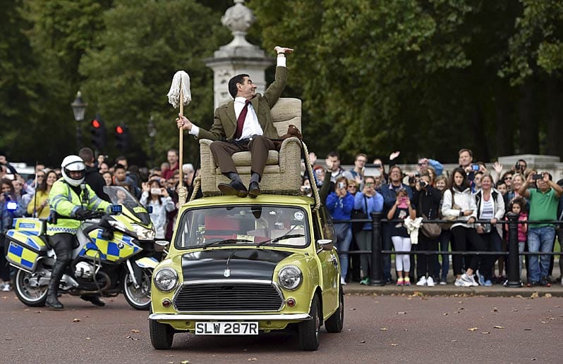 Es ist jedenfalls kein Fahrer am Steuer des mit Geschenken vollgestopften Autos zu sehen. Dafür jede Menge Fans, die Mr. Bean zujubeln.
