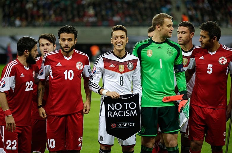 Vor dem Anpfiff setzen sie Teams ein Zeichen gegen Rassismus.