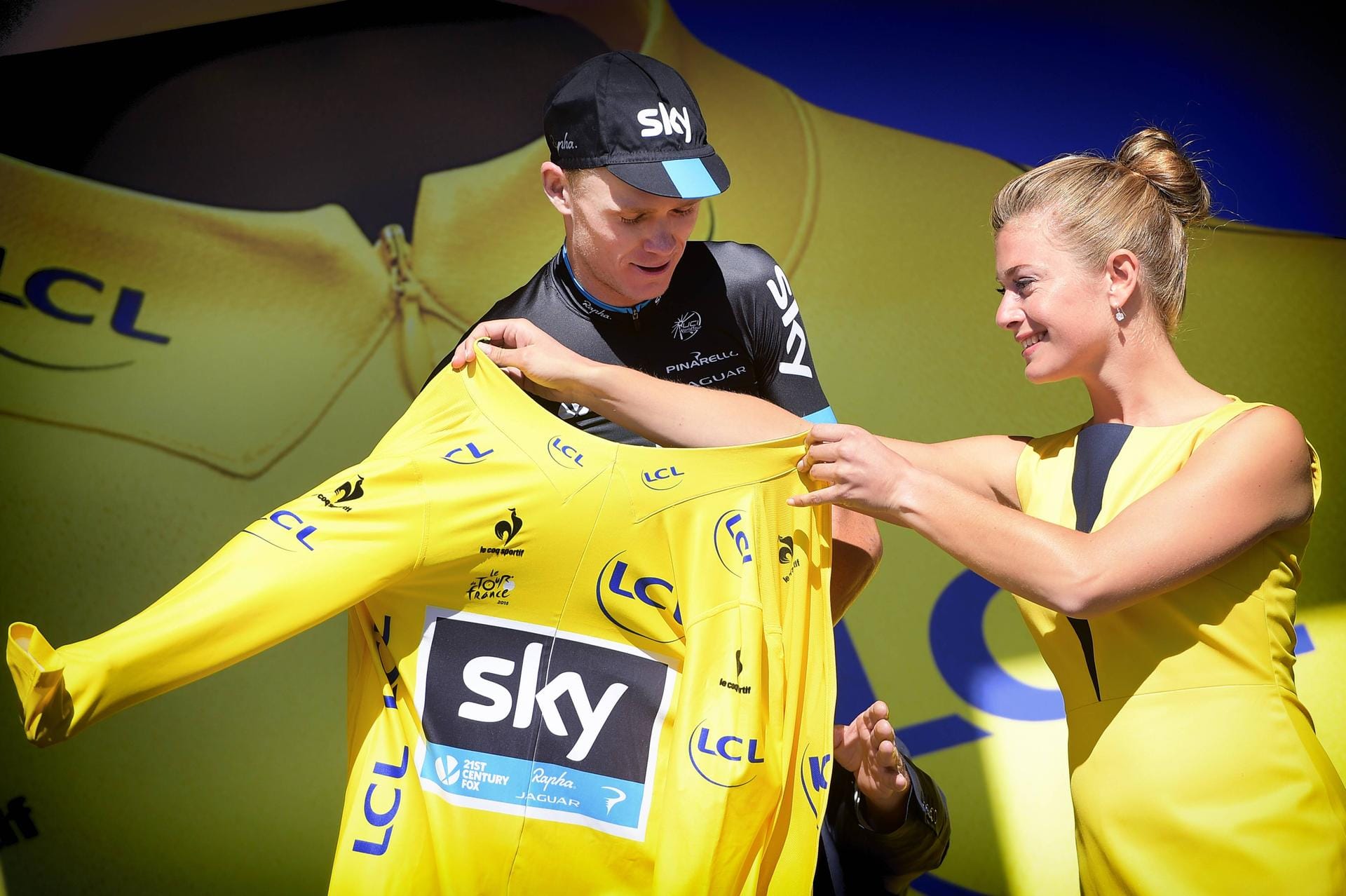 Ankleidedame: Christopher Froome bekommt bei der Tour de France höchst attraktive Hilfe mit seinem Gelben Trikot.