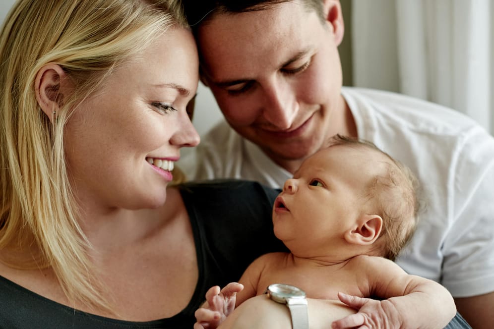 Ein Paar mit einem Baby: Das Kindeswohl steht bei einer Adoption im Vordergrund.