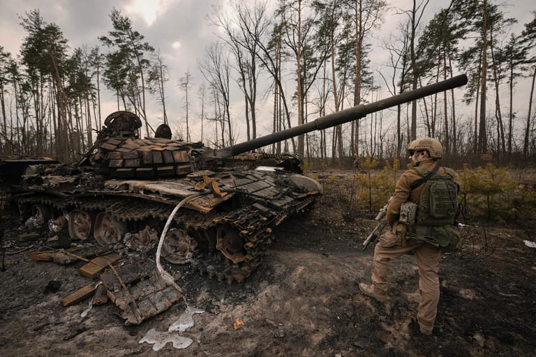 31. März: Nach einem teilweisen Rückzug der Russen entspannt sich die Lage in Kiew nach Angaben des Stadtkommandanten etwas. Die Nato geht davon aus, dass sich russische Einheiten nur neu positionieren. Im Bild: Ein ukrainischer Soldat steht am Stadtrand von Kiew neben einem zerstörten Panzer.