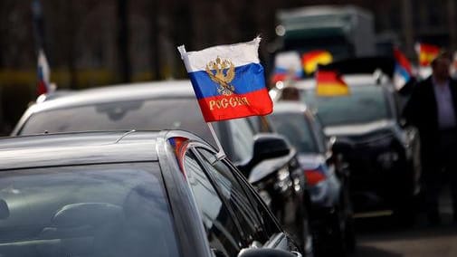 Flaggen mit den russischen Nationalfarben wehen an einem Auto in Berlin (Symbolbild): In Bad Kreuznach war auch zunächst ein Autokorso geplant.