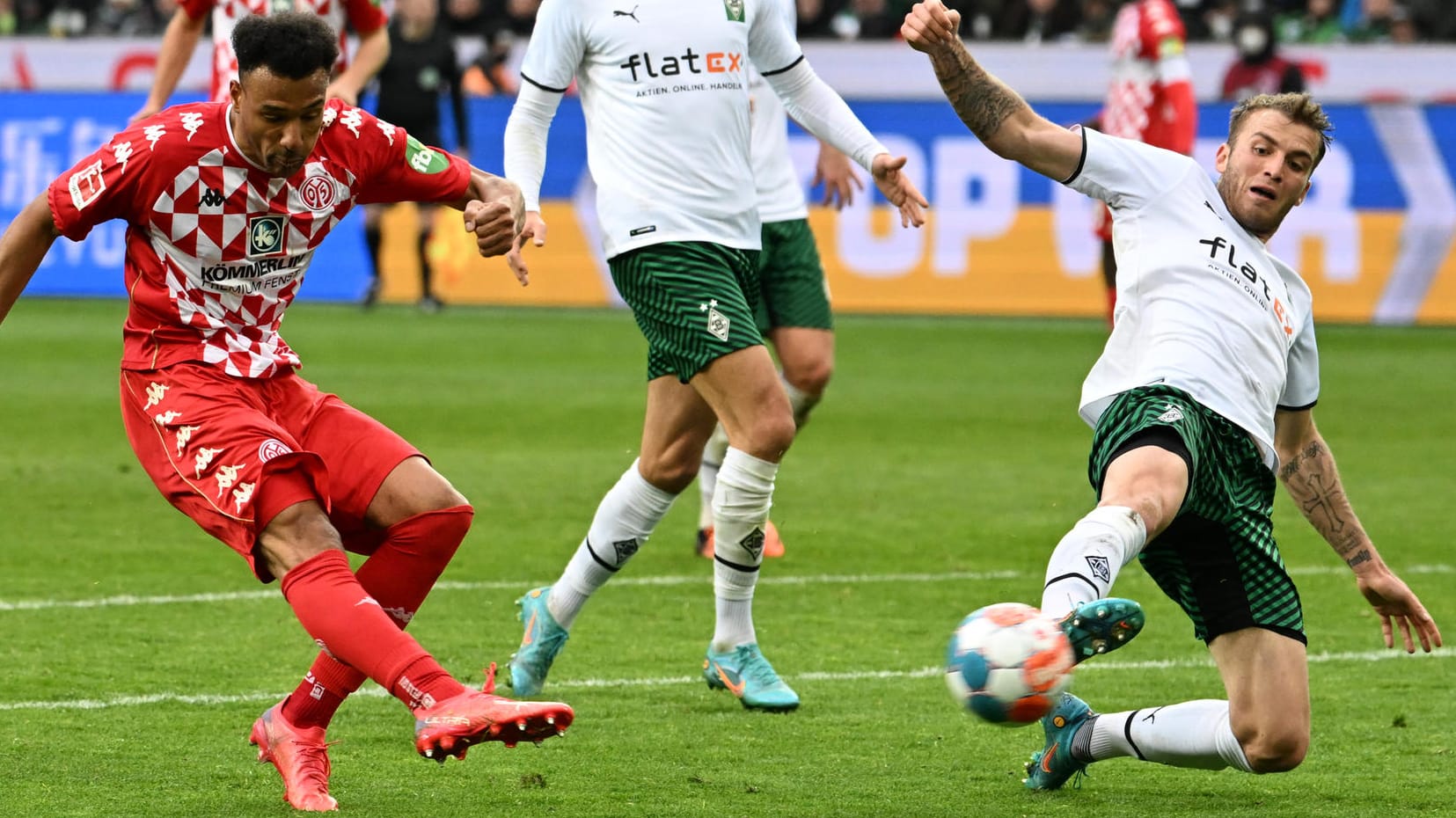 Karim Onisiwo (l.) zieht ab, Jordan Beyer versucht zu blocken: Die Partie in Gladbach war eine mit zwei völlig verschiedenen Halbzeiten.