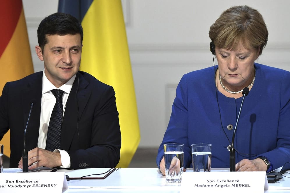 Wolodymyr Selenskyj und Angela Merkel bei einem Treffen in Paris (Archivbild): Der ukrainische Präsident hat jetzt die Russlandpolitik der Ex-Kanzlerin kritisiert.
