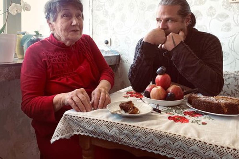 Die Holocaust-Überlebende Hanna Stryschkowa und der Fotograf und Filmemacher Luigi Toscano aus Mannheim unterhalten sich an einem Tisch.