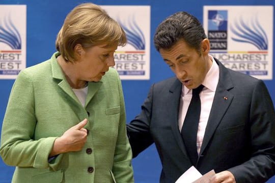 Die damalige Bundeskanzlerin Angela Merkel (l, CDU) spricht mit Nicolas Sarkozy, damals Präsident von Frankreich, am Ende der Eröffnungssitzung des NATO-Gipfels.