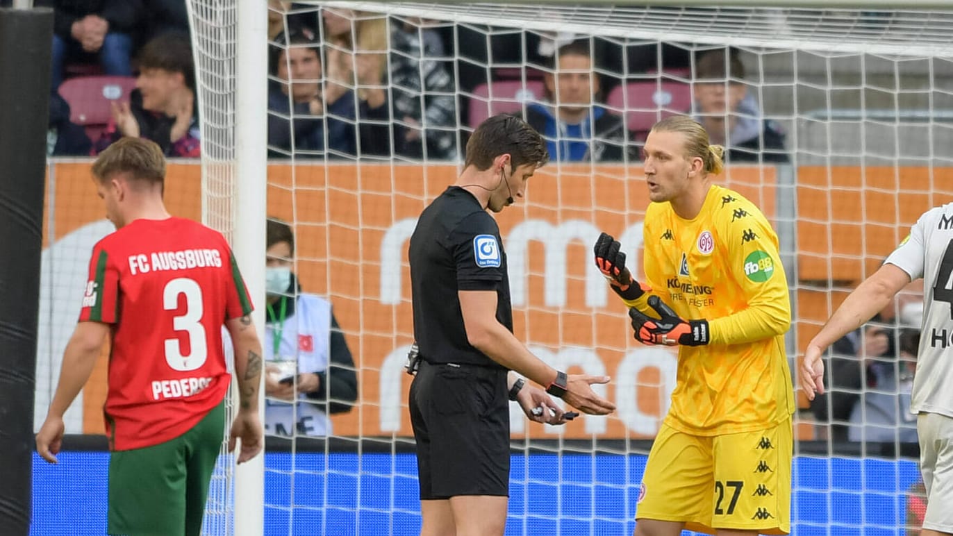 Ärger nach Elfmeterentscheidung: Mainz-Keeper Robin Zentner (gelbes Trikot) diskutiert mit Schiedsrichter Dr. Matthias Jöllenbeck über dessen Elfmeterentscheidung in der 11. Minute.