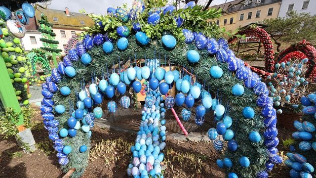 Mit bunten Ostereiern geschmückt zeigt sich die Osterkrone rund um einen Osterbrunnen (Symbolbild): In die Fränkischen Schweiz kommen ganze Busse gefahren, um dies zu sehen.