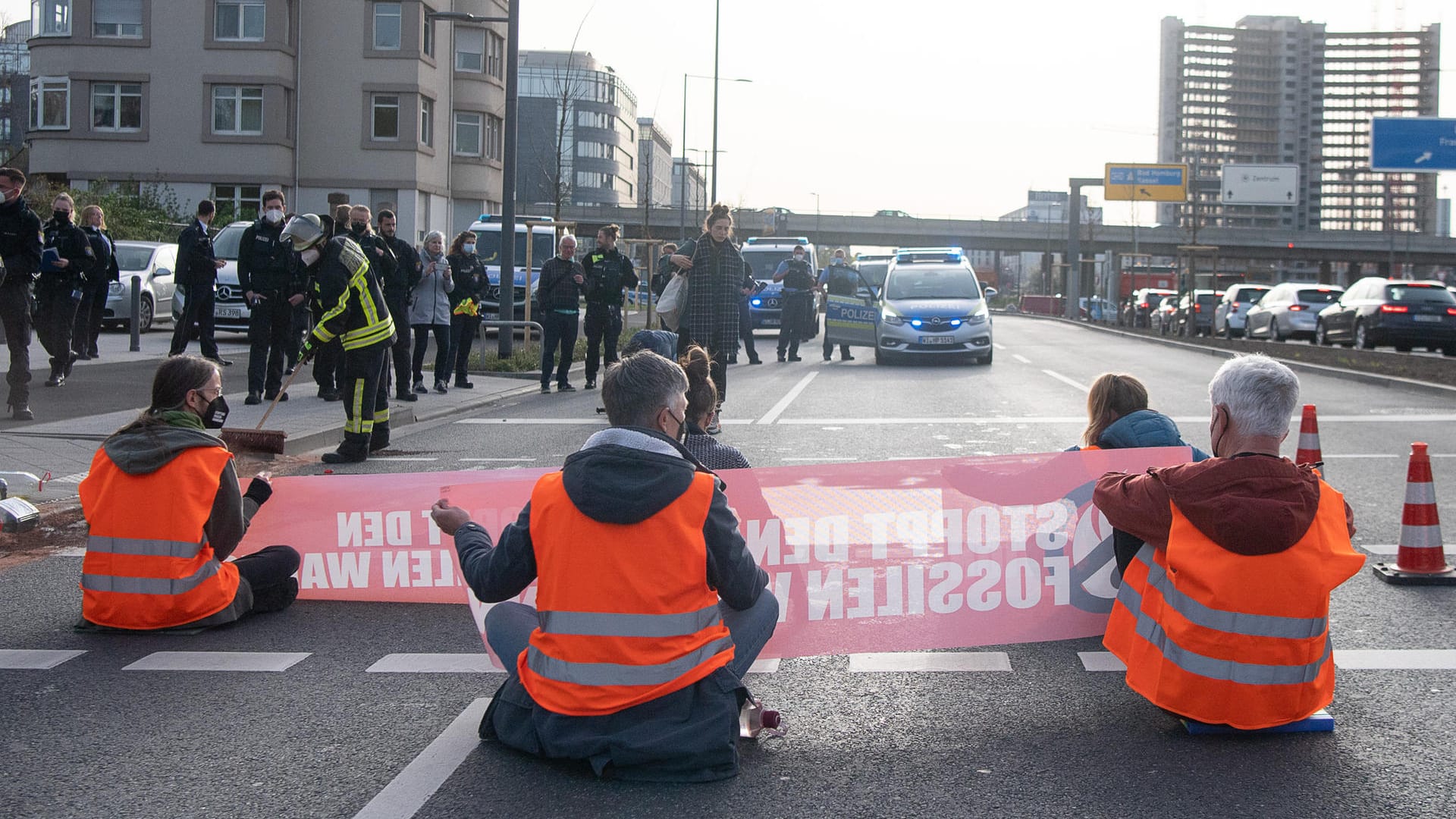 Aktivisten sitzen während eines Protests auf der Straße: Die "Letzte Generation" verteilte Fake-Öl über die Straße.