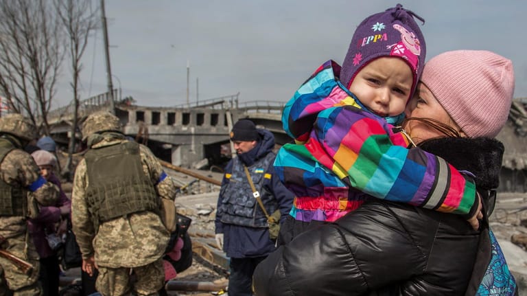 Mutter mit Kind in der zerstörten Stadt Irpin: Das UN-Kinderhilfswerk Unicef schätzt, dass fast zwei Drittel aller ukrainischen Kinder auf der Flucht sind.