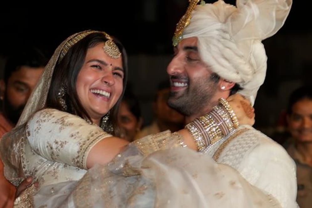 Die Bollywood-Schauspieler Ranbir Kapoor (r) und Alia Bhatt nach ihrer Hochzeit vor ihrem Haus in Mumbai.