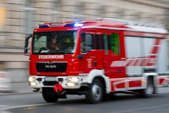Ein Feuerwehrfahrzeug ist mit Blaulicht auf Einsatzfahrt (Symbolbild): Eine Person musste in ein Krankenhaus gebracht werden.