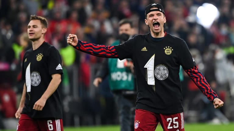 Bayerns Nationalspieler Joshua Kimmich (l.) und Thomas Müller mit den Meister-T-Shirts beim Versuch, möglichst ausgelassen zu wirken.