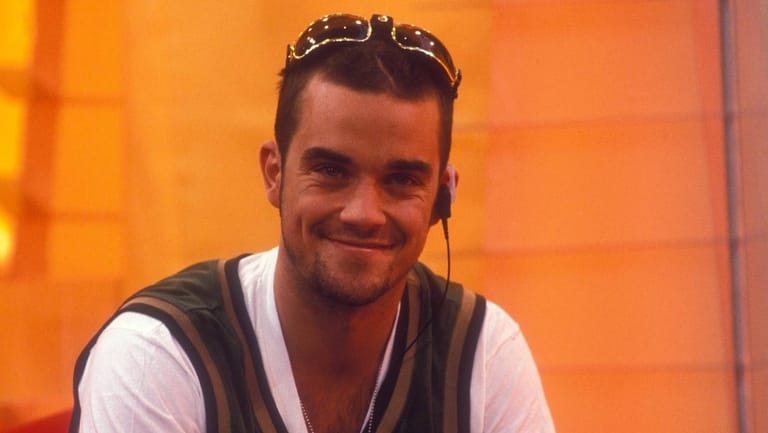 Immer ein verschmitztes Lächeln im Gesicht: Robbie Williams hat Take That im Jahr 1995 nach Drogen- und Partyexzessen verlassen.