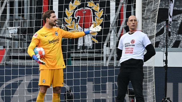 Frankfurts Torwart Kevin Trapp (l) diskutiert mit einem der Protestler.