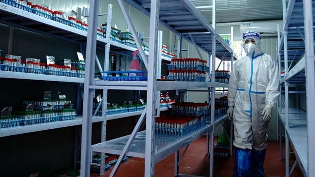 Dieses von der chinesischen Staatsagentur Xinhua verbreitete Bild zeigt den Mitarbeiter eines Corona-Testlabors in Shanghai. Dieses von der chinesischen Staatsagentur Xinhua verbreitete Bild zeigt den Mitarbeiter eines Corona-Testlabors in Shanghai.