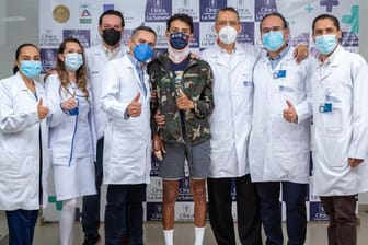 Egan Bernal (M) zeigt mit dem Daumen hoch umgeben von Mitarbeitern des Uni-Klinikums de la Sabana, zwei Wochen nach dem Sturz.