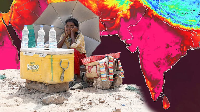 Hitze in Indien: Ein Mädchen verkauft am Straßenrand in Neu-Delhi Wasser und schützt sich vor der gleißenden Sonne.