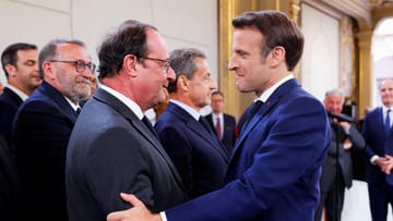 Francois Hollande (l) congratulates Emmanuel Macron (r) on his re-election: Macron won over right-wing populist Marine Le Pen.