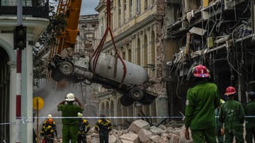 Havana, Cuba: A crane pulls a tanker truck out of the rubble of the Saratoga Hotel.