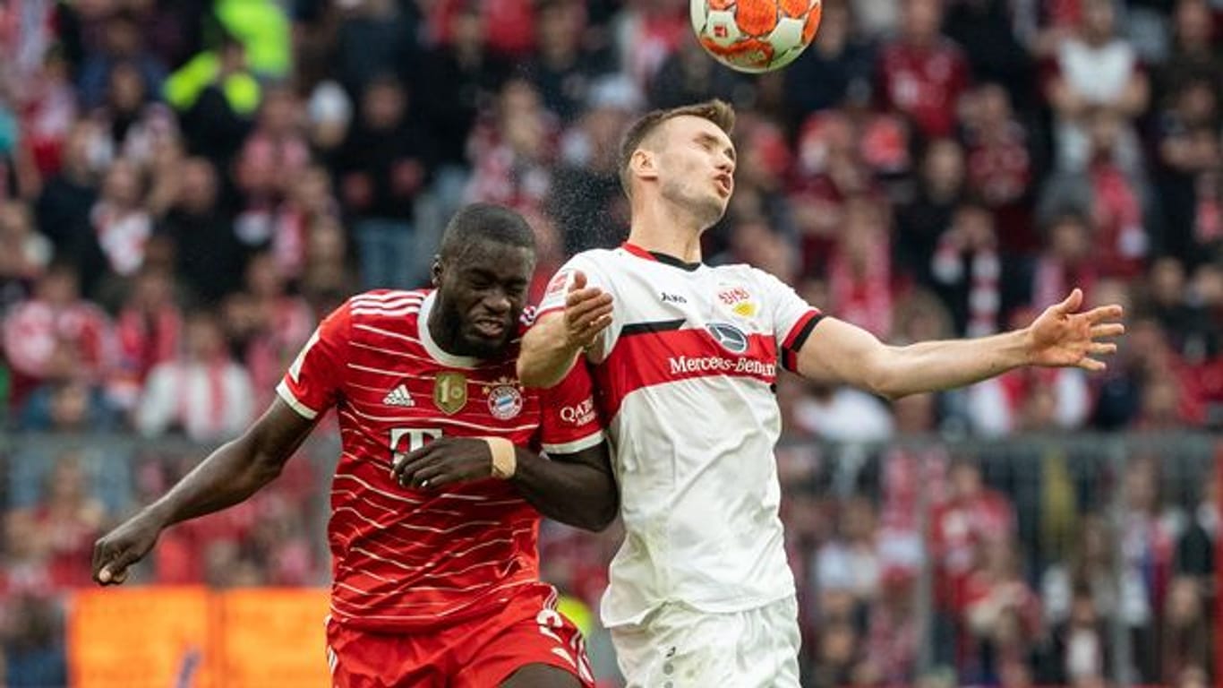 Dayot Upamecano vom FC Bayern München (l) und Sasa Kalajdzic von Stuttgart kämpfen im Kopfballduell um den Ball.
