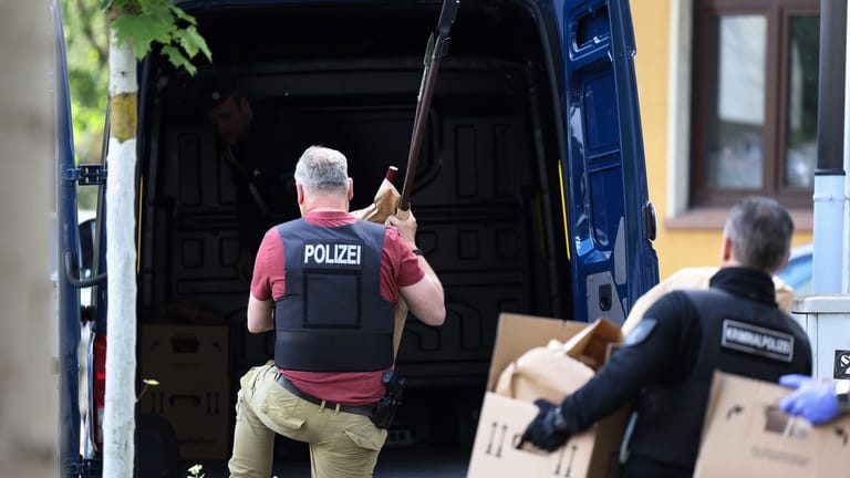 Polizisten tragen Gegenstände, darunter mehrere Stichwaffen und Speere, aus dem Wohnhaus des Verdächtigen: Der 16-Jährige sitzt nun in Untersuchungshaft.