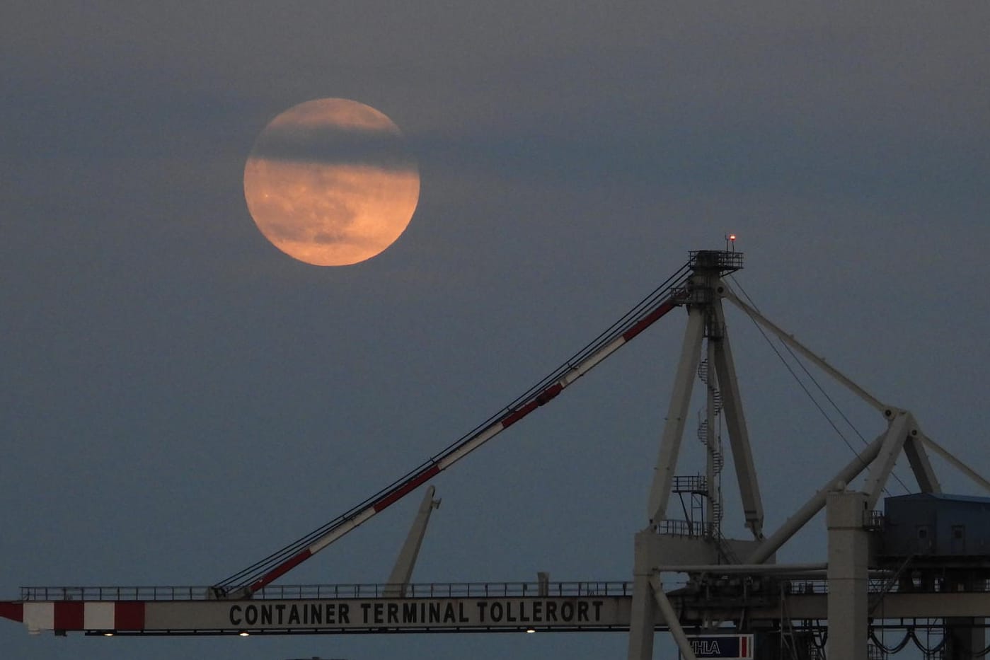 Der Mond über einem Kran in Hamburg.