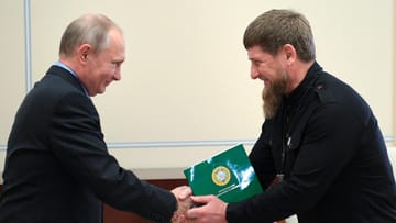 Beautiful best friends: Putin and his Chechen governor Kadyrov shake hands.