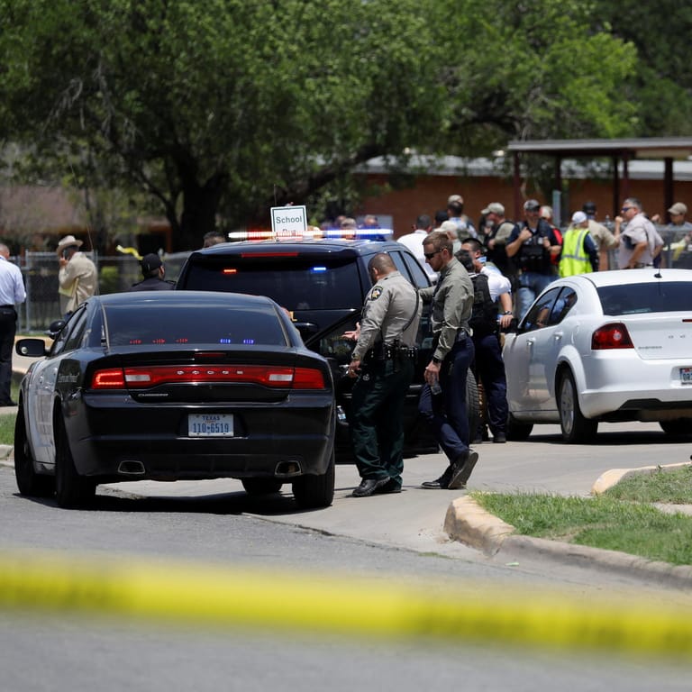 Polizisten stehen vor der Schule, in der ein 18-Jähriger 19 Kinder tötete.