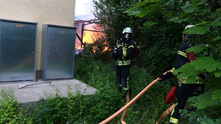 Die Feuerwehr bei einem Gartenbrand (Symbolfoto): Bei steigender Hitze können einzelne Flammen schnell zu einem Großbrand umschlagen.