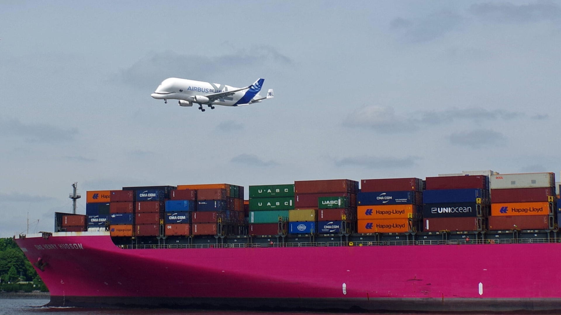 Flugzeug überfliegt einen Containerfrachter (Symbolbild): Die Importzahlen spiegeln auch die Auswirkungen des Kriegs in der Ukraine wider.