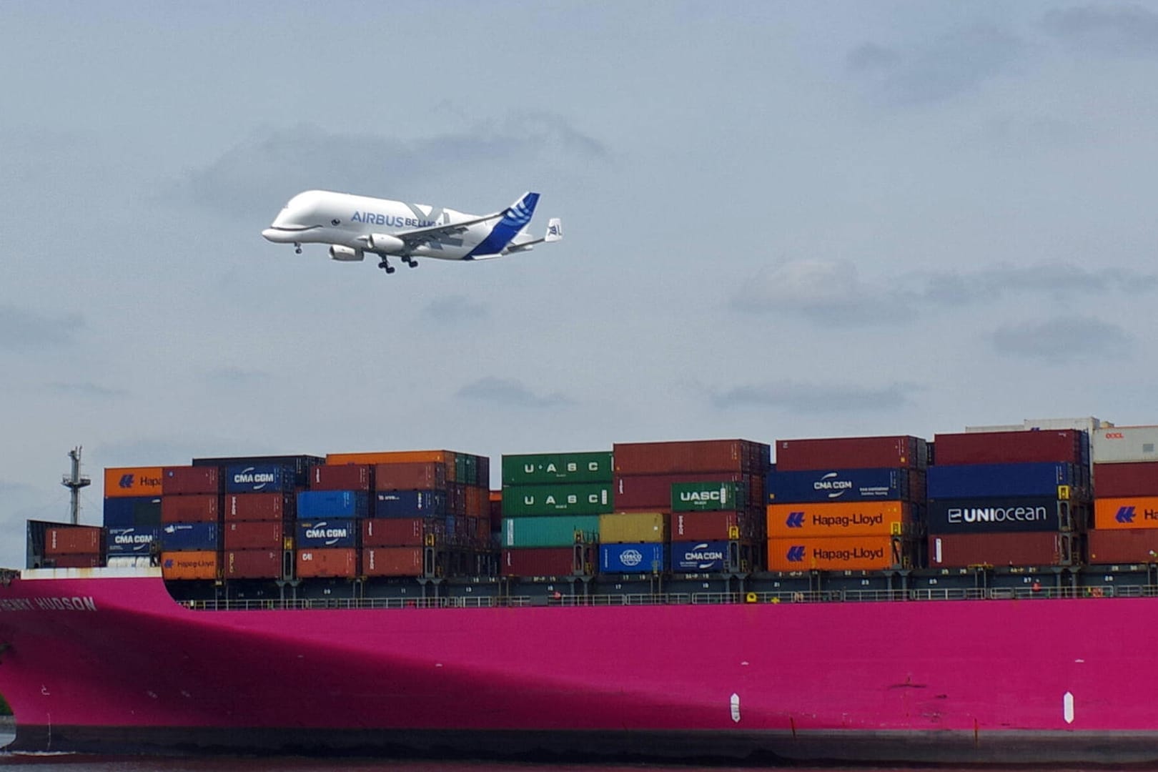 Flugzeug überfliegt einen Containerfrachter (Symbolbild): Die Importzahlen spiegeln auch die Auswirkungen des Kriegs in der Ukraine wider.