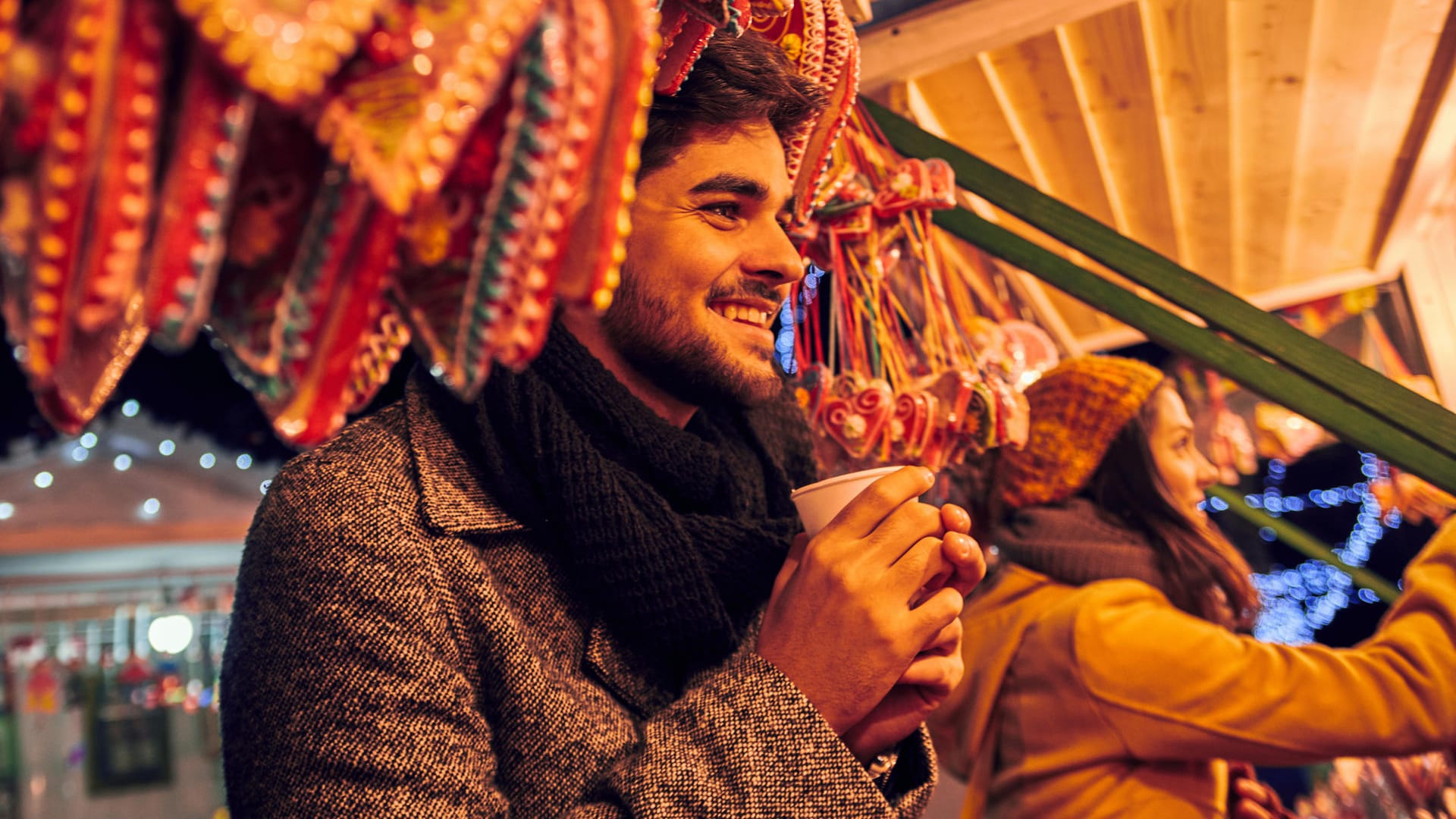 Mann auf dem Weihnachtsmarkt: Zu den absoluten Kalorienbomben auf dem Weihnachtsmarkt gehören Eierpunsch und Glühwein. Es gibt aber kalorienärmere Alternativen.