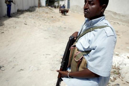 Ein schwer bewaffnetet Soldat hält in Mogadischu Wache: Die Terrorgruppe Al-Schaabab verübt immer wieder Anschläge auf Sicherheitskräfte und Zivilisten.