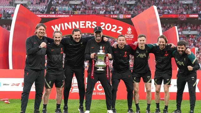 Liverpools Coach Jürgen Klopp (M) feiert den Gewinn des FA Cups mit seinem Trainerteam.