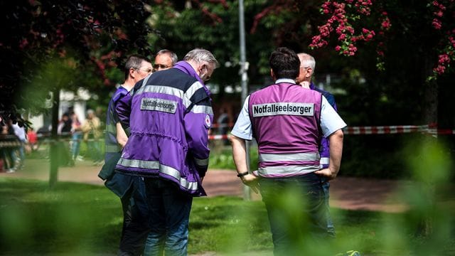 Notfallseelsorger stehen vor dem Gymnasium in Bremerhaven.