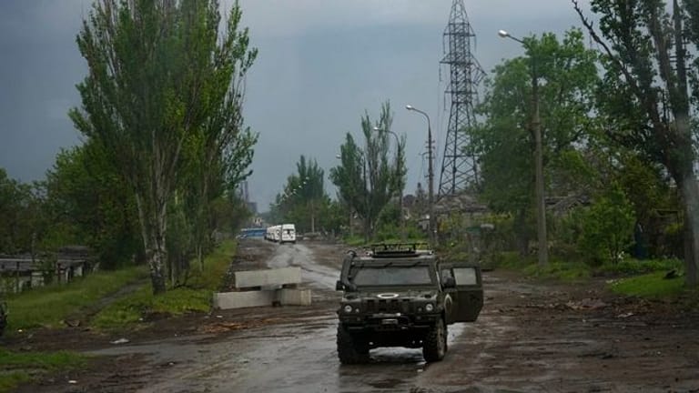 Ein russisches gepanzertes Fahrzeug bewacht die Straße zum belagerten Stahlwerk Azovstal während einer Evakuierung in Mariupol.
