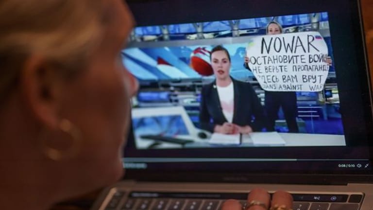 Mit einem Protestplakat und lauten Rufen hatte eine Kriegsgegnerin im russischen Staatsfernsehen für eine Unterbrechung der Hauptnachrichtensendung gesorgt.