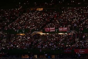 Zuschauer leuchten während des Stromausfalls im Ernst-Happel-Stadion mit ihren Mobiltelefonen.