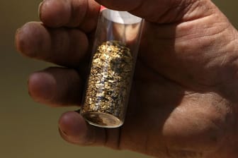Goldflocken im Glas (Symbolbild): Weltweit gibt es nach Schätzungen in Lagerstätten noch Goldreserven von rund 54.000 Tonnen.