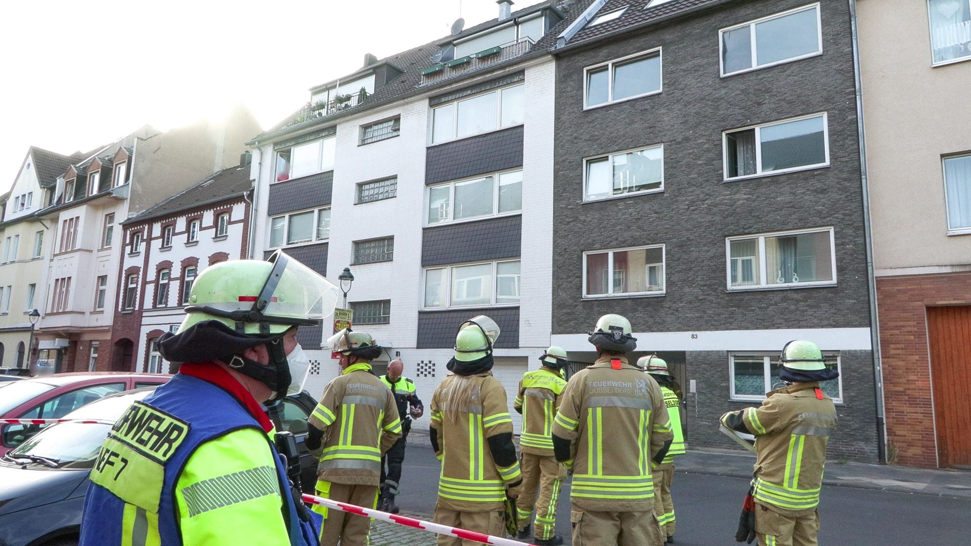 Einsatzkräfte der Feuerwehr stehen vor dem Wohnhaus: Die Hitze hat Glasbausteine bersten lassen. Einsatzkräfte der Feuerwehr stehen vor dem Wohnhaus: Die Hitze hat Glasbausteine bersten lassen.
