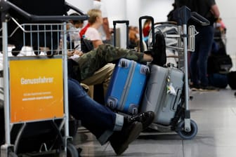Passagiere warten am Flughafen in München: Zahlreiche Reisende versuchen am Mittwoch an deutschen Flughäfen, doch noch wegzukommen.