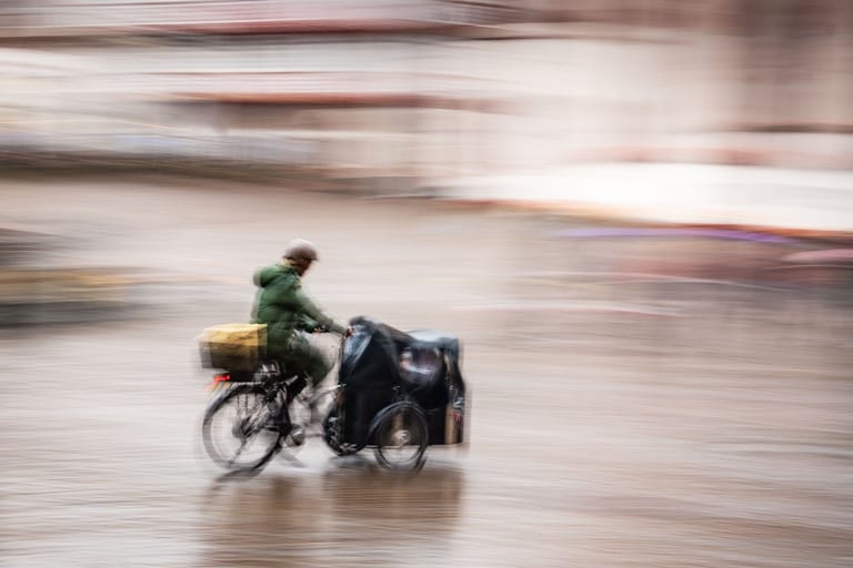 Ein Mann fährt an einem regnerischen und windigen Sonntag über den Römerberg (Symbolbild). In Niedersachsen fällt die Förderung von Lastenrädern zukünftig weg.