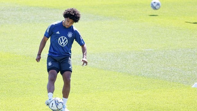 Serge Gnabry spielt auf dem Trainingsplatz in Herzogenaurach mit dem Ball.