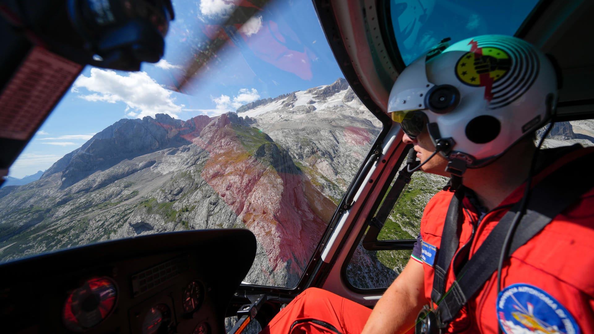 Ein Retter steuert einen Hubschrauber, um nach den Opfern der Gletscherlawine von Punta Rocca zu suchen: Fünf Menschen gelten noch als vermisst. Ein Retter steuert einen Hubschrauber, um nach den Opfern der Gletscherlawine von Punta Rocca zu suchen: Fünf Menschen gelten noch als vermisst.