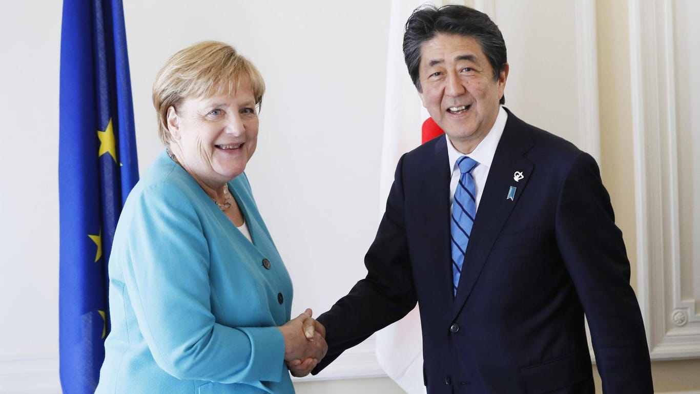 Japan Germany talks Japanese Prime Minister Shinzo Abe and German Chancellor Angela Merkel shake ha